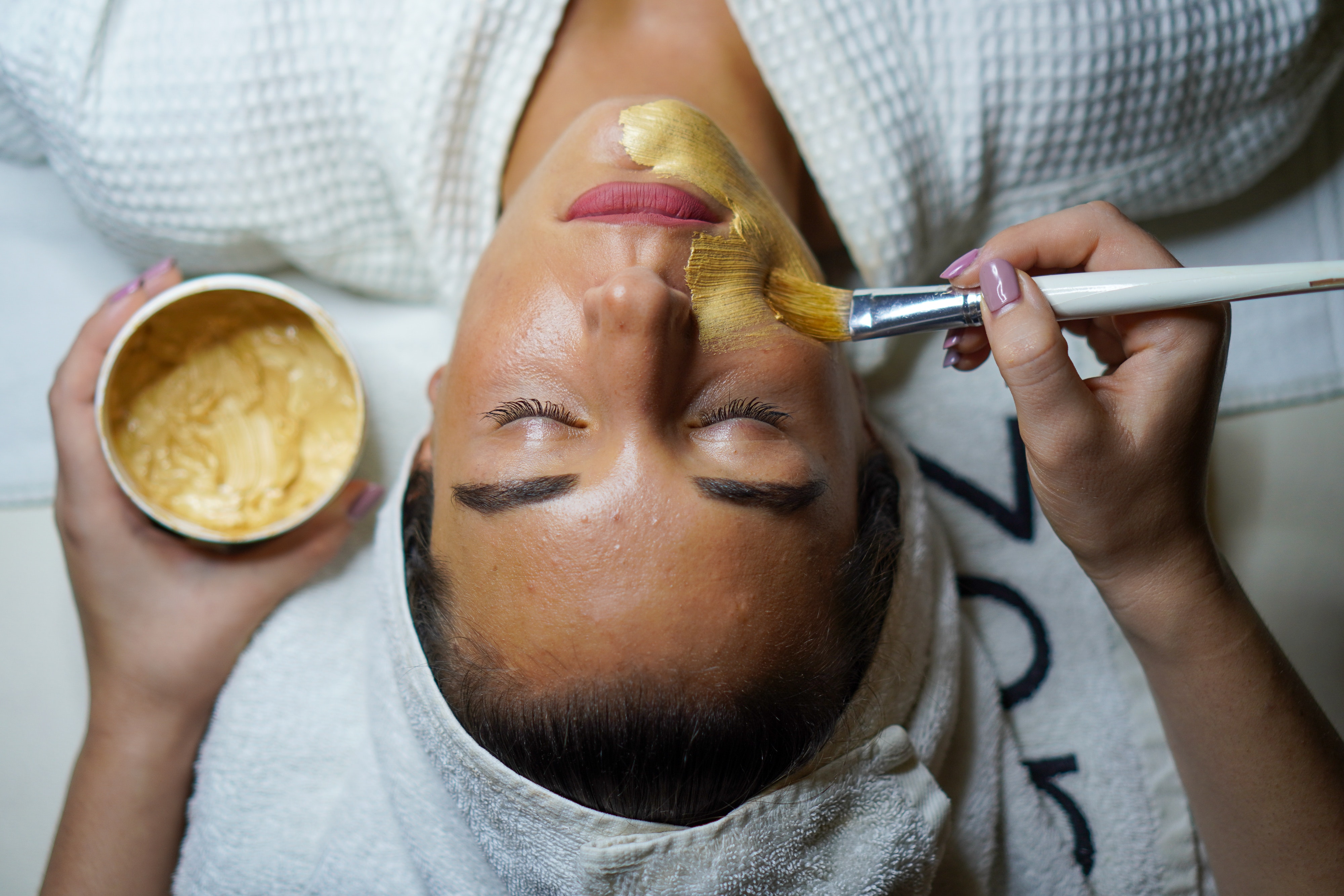 Photo of a woman getting a facial mask
